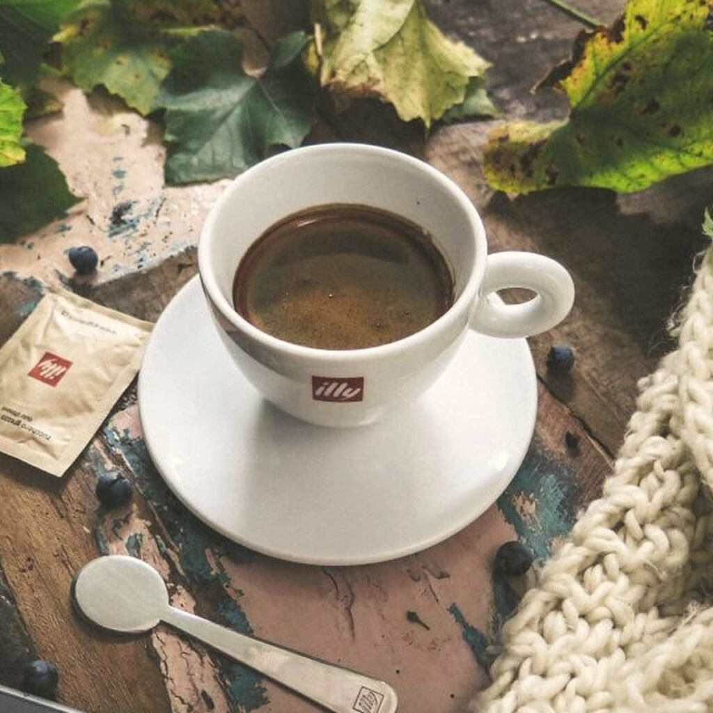 Coffee, linen and a knit throw on a table