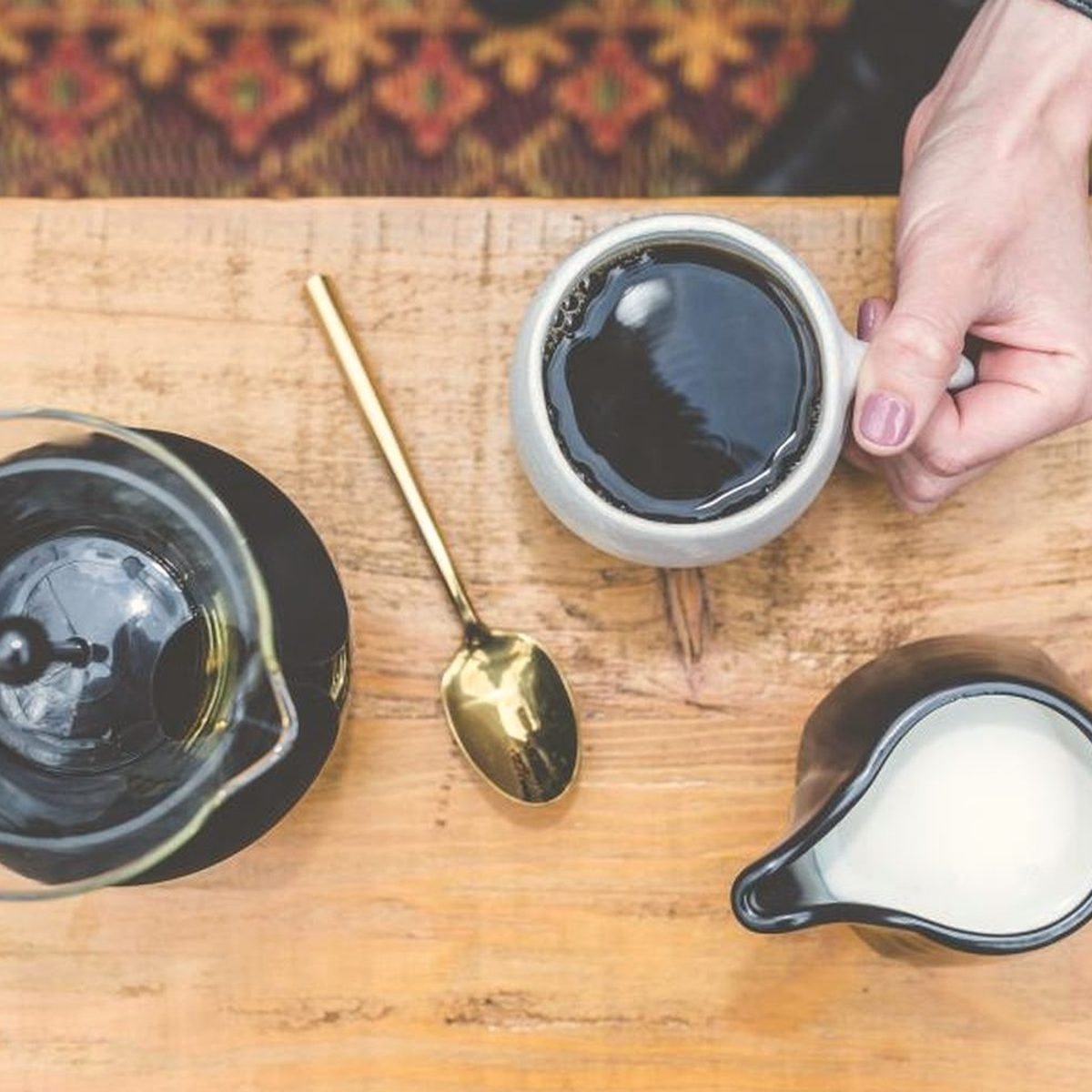 Coffee being poured on a wooden table